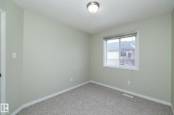 Spare room with a textured ceiling and carpet - 