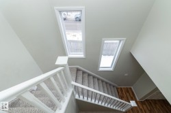 Stairs with baseboards and wood finished floors - 