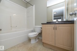 Bathroom with vanity, shower / washtub combination, and light tile patterned floors - 