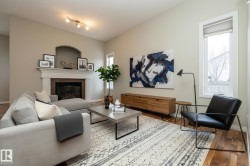 Living area with a glass covered fireplace and wood finished floors - 