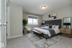 Bedroom featuring light carpet and baseboards - 