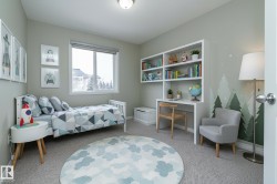 Bedroom featuring light carpet and baseboards - 