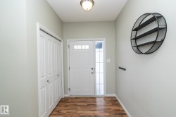 Entryway with dark wood-style floors and baseboards - 