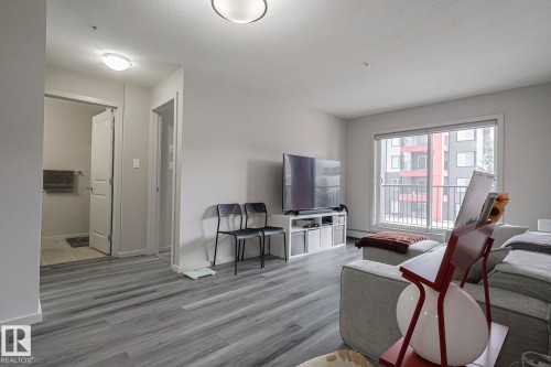 Living room with wood finished floors and a textured ceiling - 236 344 Windermere Road, Edmonton, AB - Indoor Photo Showing Living Room