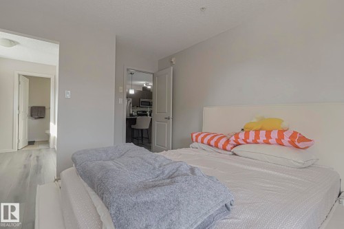 Bedroom featuring wood finished floors and a textured ceiling - 236 344 Windermere Road, Edmonton, AB - Indoor Photo Showing Bedroom
