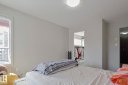 Bedroom featuring a spacious closet and a textured ceiling - 