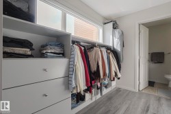 Walk in closet featuring light wood-style flooring - 
