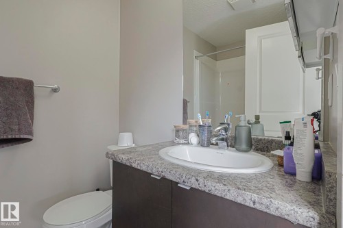 Full bathroom featuring vanity, a textured ceiling, and a shower - 236 344 Windermere Road, Edmonton, AB - Indoor Photo Showing Bathroom