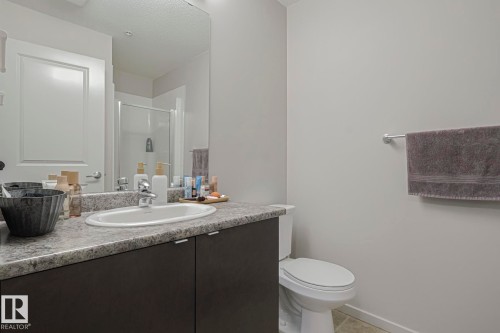 Bathroom with vanity, a shower stall, light tile patterned floors, and a textured ceiling - 236 344 Windermere Road, Edmonton, AB - Indoor Photo Showing Bathroom