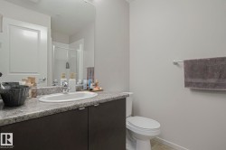 Bathroom with vanity, a shower stall, light tile patterned floors, and a textured ceiling - 