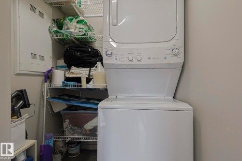 Laundry room featuring stacked washer / dryer and electric panel - 236 344 Windermere Road, Edmonton, AB - Indoor Photo Showing Laundry Room