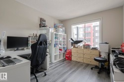 Home office with a textured ceiling and light wood finished floors - 