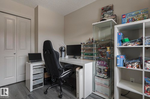 Office featuring dark wood-style floors and a textured ceiling - 236 344 Windermere Road, Edmonton, AB - Indoor Photo Showing Office