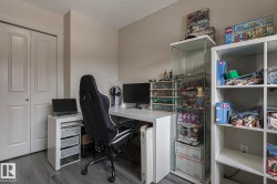 Office featuring dark wood-style floors and a textured ceiling - 