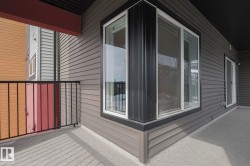 View of side of home featuring a balcony - 