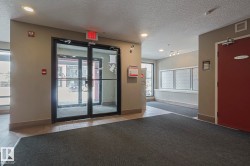 Community lobby featuring a textured ceiling and recessed lighting - 