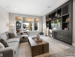 Living room featuring light colored carpet and baseboards - 