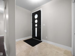 Entryway featuring baseboards and light tile patterned flooring - 