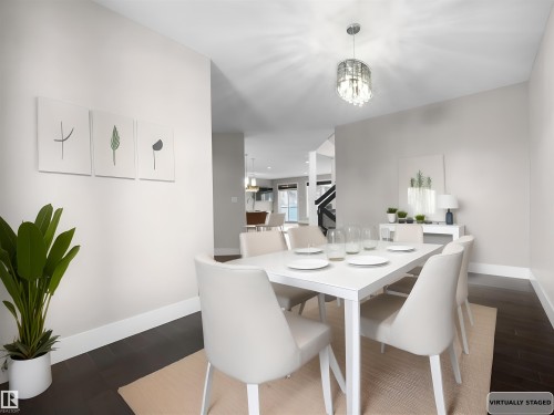 Dining area featuring dark wood finished floors and a chandelier - 59 10550 Ellerslie Road, Edmonton, AB - Indoor Photo Showing Dining Room