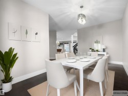 Dining area featuring dark wood finished floors and a chandelier - 
