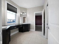 Full bath with double vanity and light tile patterned flooring - 