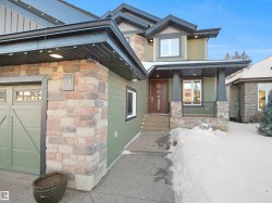 View of front facade with covered porch and stone siding - 