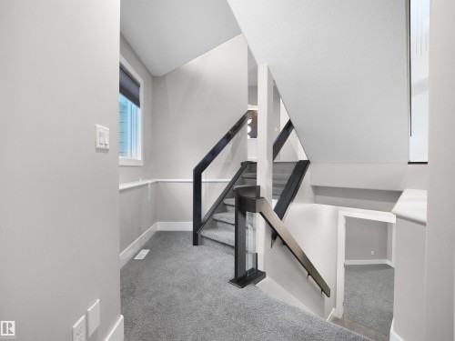 Stairs with carpet and baseboards - 59 10550 Ellerslie Road, Edmonton, AB - Indoor Photo Showing Other Room