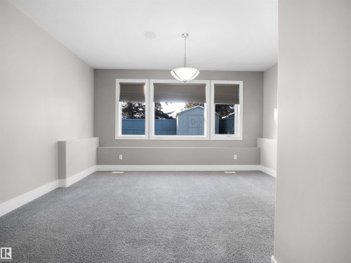 Spare room with light colored carpet and baseboards - 59 10550 Ellerslie Road, Edmonton, AB - Indoor Photo Showing Other Room