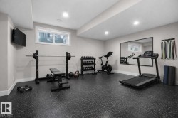 Workout area with plenty of natural light, dark flooring, and recessed lighting - 
