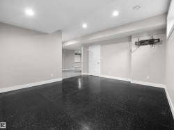 Finished below grade area with baseboards and recessed lighting - 