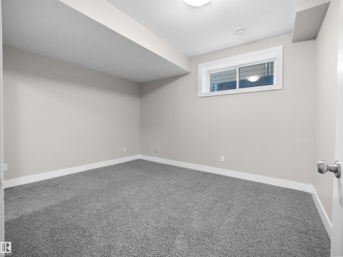Bonus room with carpet floors and baseboards - 59 10550 Ellerslie Road, Edmonton, AB - Indoor Photo Showing Other Room