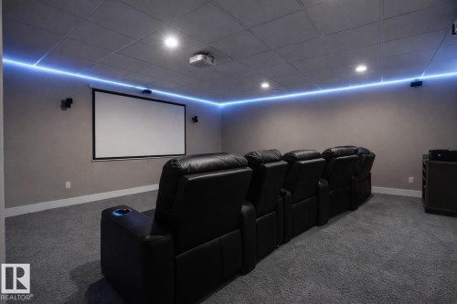 Carpeted cinema room featuring a paneled ceiling and baseboards - 59 10550 Ellerslie Road, Edmonton, AB - Indoor