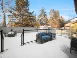 Snow covered patio featuring a shed, a fenced backyard, an outdoor hangout area, and outdoor dining area - 