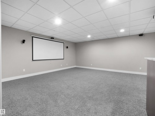 Cinema room with a paneled ceiling and light carpet - 59 10550 Ellerslie Road, Edmonton, AB - Indoor