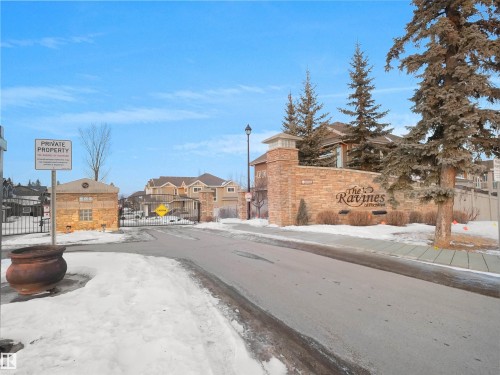 View of asphalt street with sidewalks, a residential view, and a gated entry - 59 10550 Ellerslie Road, Edmonton, AB - Outdoor