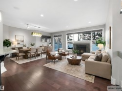 Living room featuring recessed lighting, dark wood-type flooring, and a tile fireplace - 