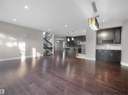 Unfurnished living room with recessed lighting and dark wood-style floors - 