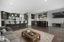 Living room featuring dark wood-type flooring, bar, recessed lighting, and wine cooler - 