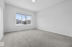 Empty room with light carpet and baseboards - 