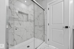 Bathroom featuring marble look tile flooring and a marble finish shower - 