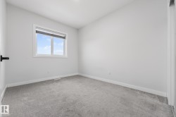 Unfurnished room featuring light colored carpet and baseboards - 