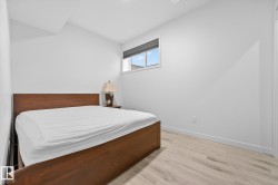 Bedroom featuring light wood-style floors and lofted ceiling - 