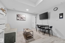 Living room featuring light wood-style flooring, recessed lighting, and attic access - 