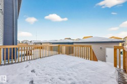 Snow covered deck featuring a residential view - 