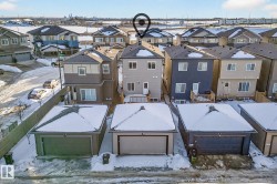 Snowy aerial view featuring a residential view - 