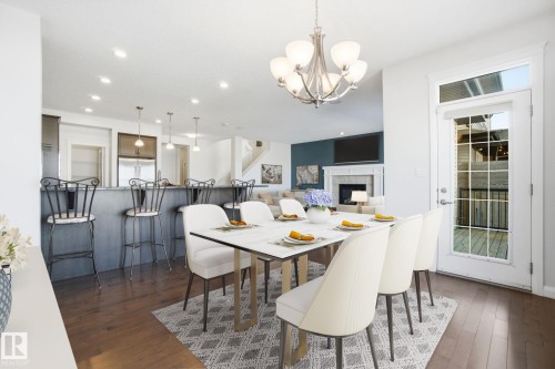 1220 Secord Landing Landing, Edmonton, AB - Indoor Photo Showing Dining Room With Fireplace