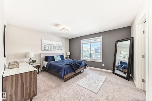 This room features light-colored carpet, a large window, and a light fixture on the ceiling - 11 Etoile Cres N, St. Albert, AB - Indoor Photo Showing Bedroom