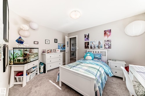 This room features light-colored carpeting, light-toned walls, and a ceiling light fixture - 11 Etoile Cres N, St. Albert, AB - Indoor Photo Showing Bedroom