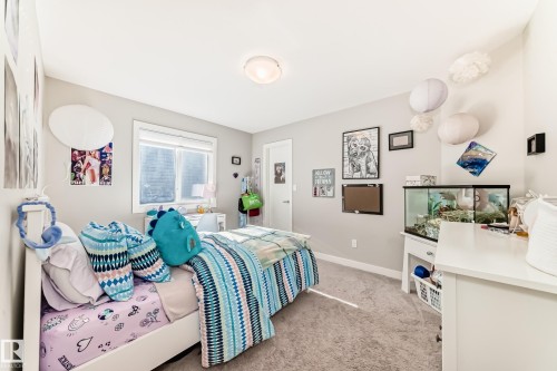 The room features light gray walls, a window with a white frame, and a ceiling light fixture - 11 Etoile Cres N, St. Albert, AB - Indoor Photo Showing Bedroom