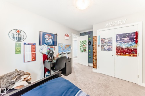 This room features light-colored carpet flooring, a built-in closet with white doors, and a ceiling light fixture - 11 Etoile Cres N, St. Albert, AB - Indoor Photo Showing Bedroom